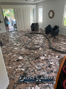 contractors removing tile floor in a home